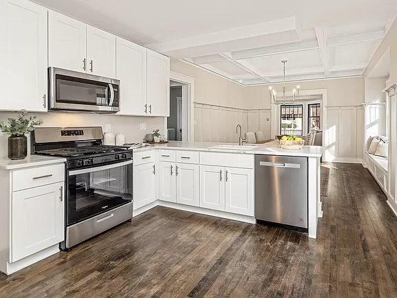 Modern and minimalist kitchen setup in Greenfield, complete with high-tech appliances and sleek surfaces