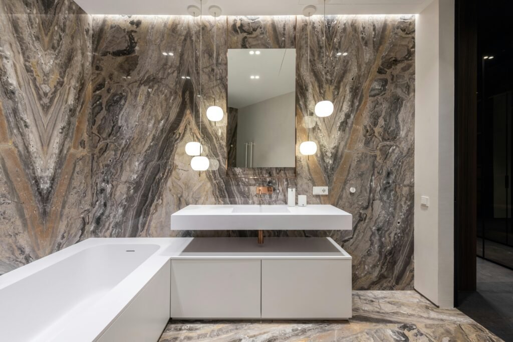 Contemporary bathroom with double sink vanity, LED mirrors, and heated floors.
