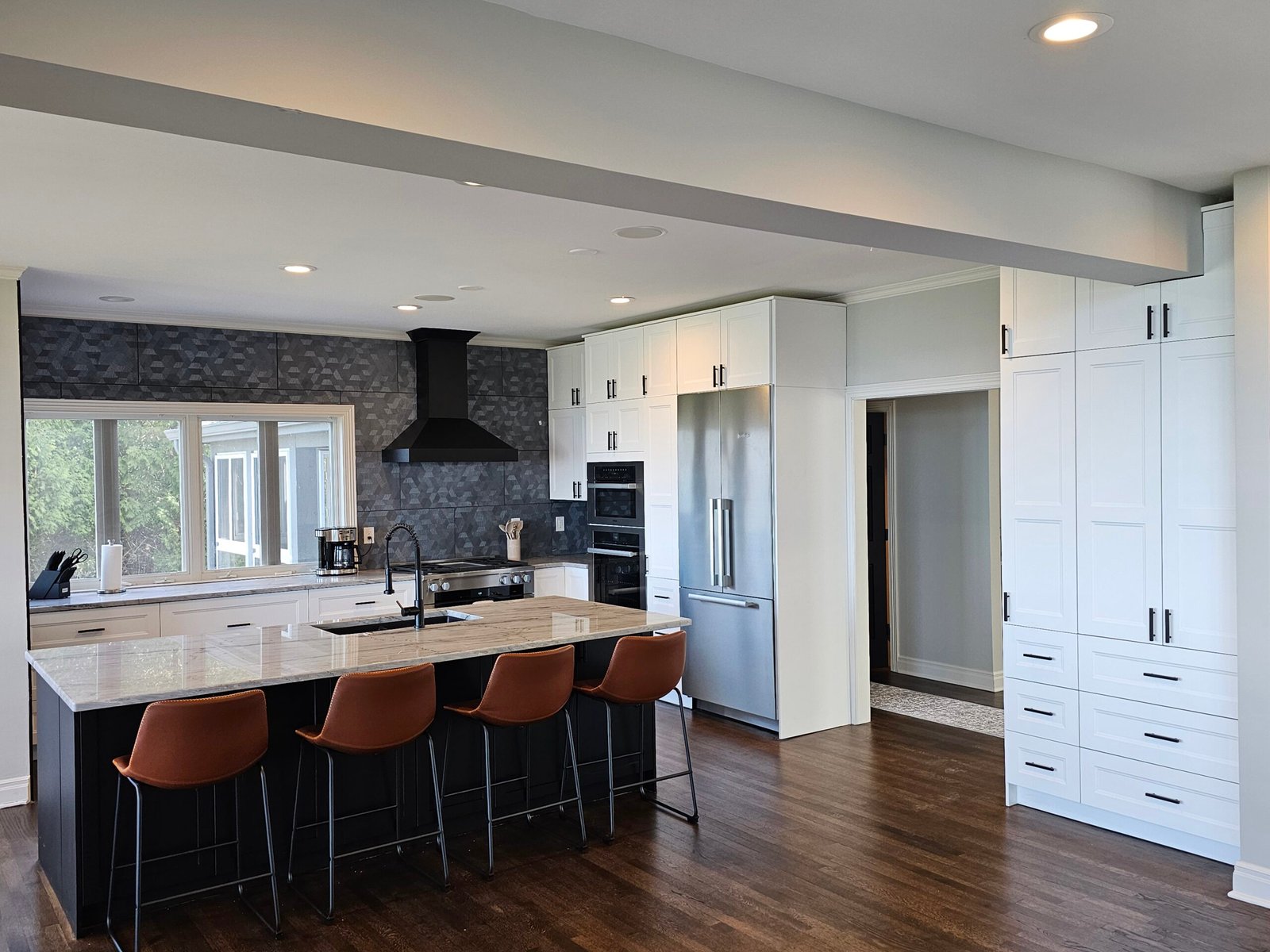 Luxury kitchen transformation in Mequon, featuring a dual oven setup and elegant stone backsplash