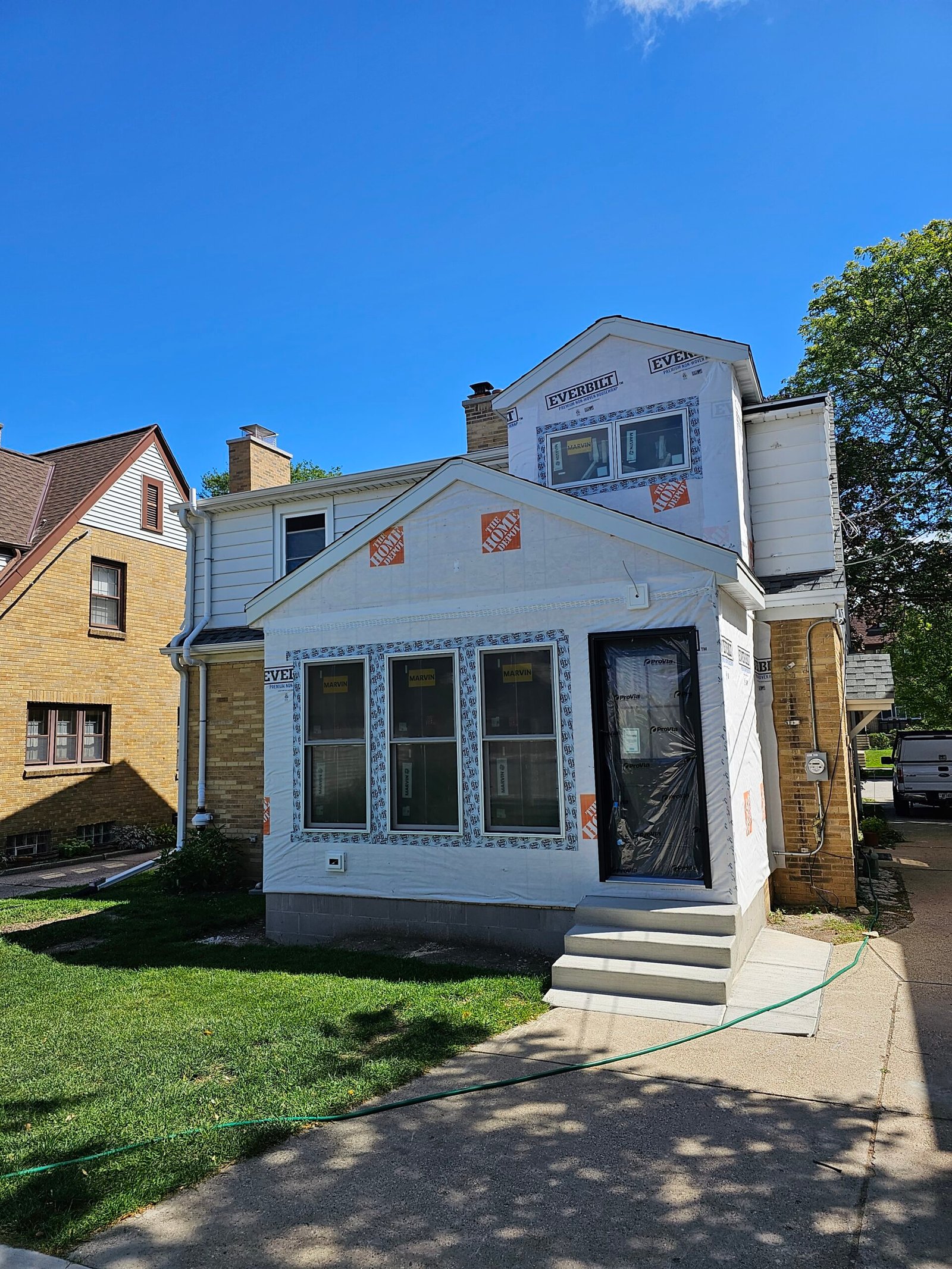 Milwaukee home featuring a new addition with large windows and custom exterior design