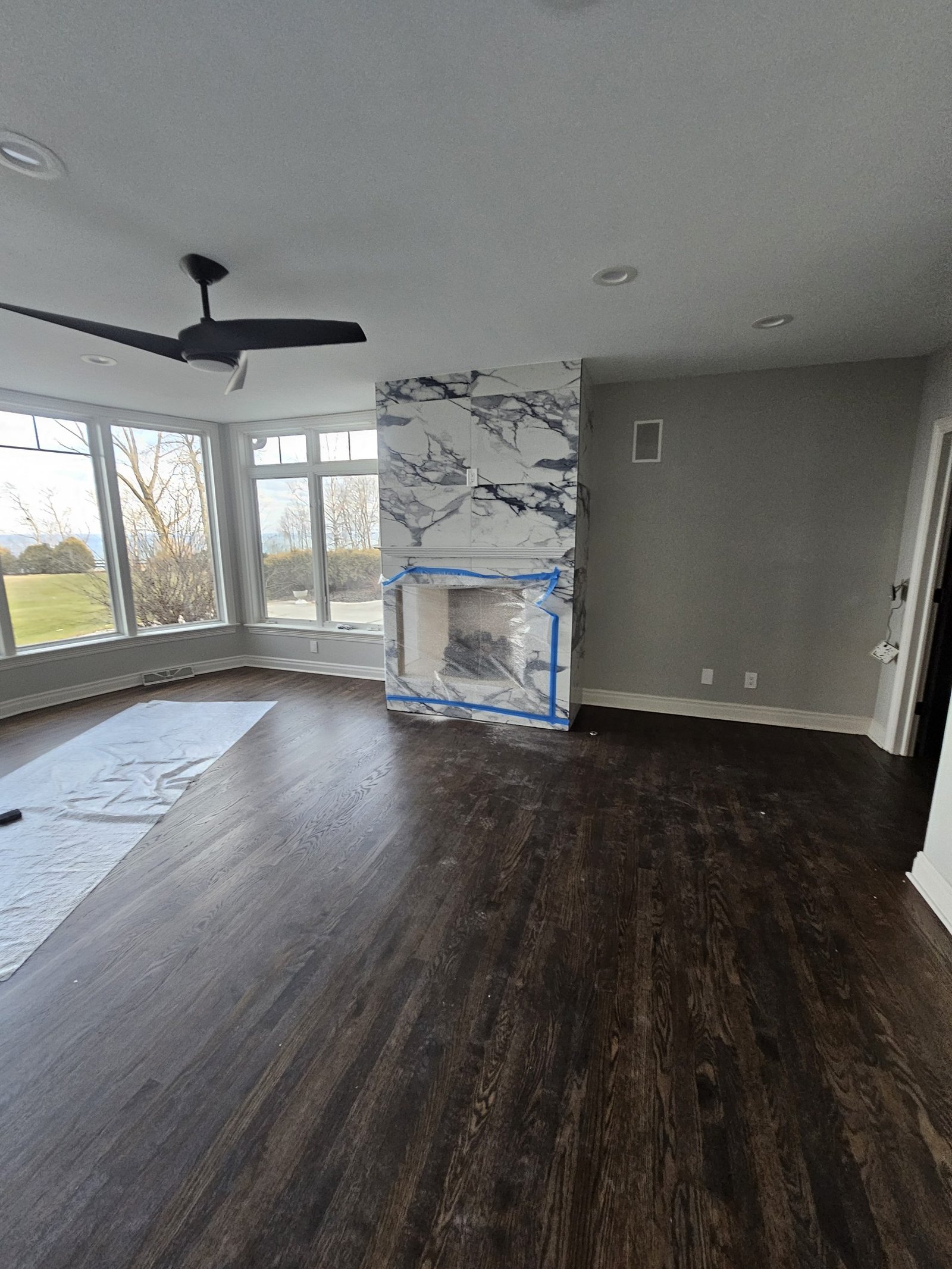 Classic chevron pattern wood flooring in a Milwaukee master bedroom setting